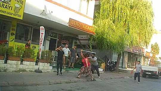 Eli sopalı kadın önüne gelen erkeği dövdü